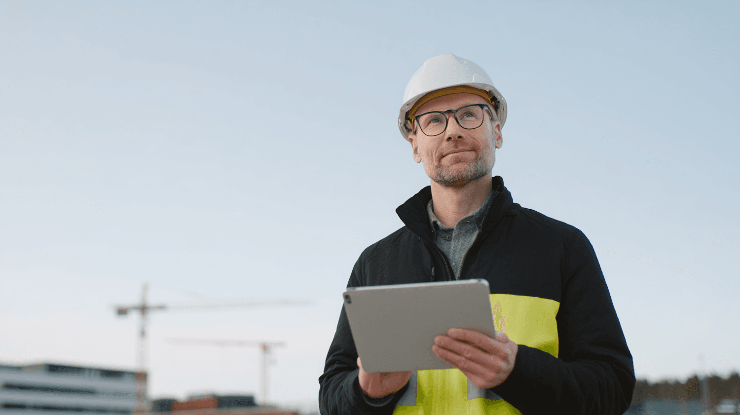 Construction professional reviewing a project on a tablet